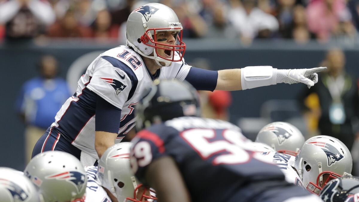 New England Patriots quarterback Tom Brady signals during a game against the Houston Texans in Houston on Dec. 1, 2013.