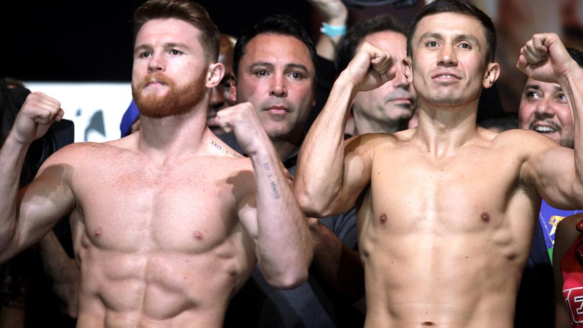 Canelo Alvarez, left, and Gennady Golovkin strike a pose after each weighed in at 160 pounds Friday in Las Vegas.