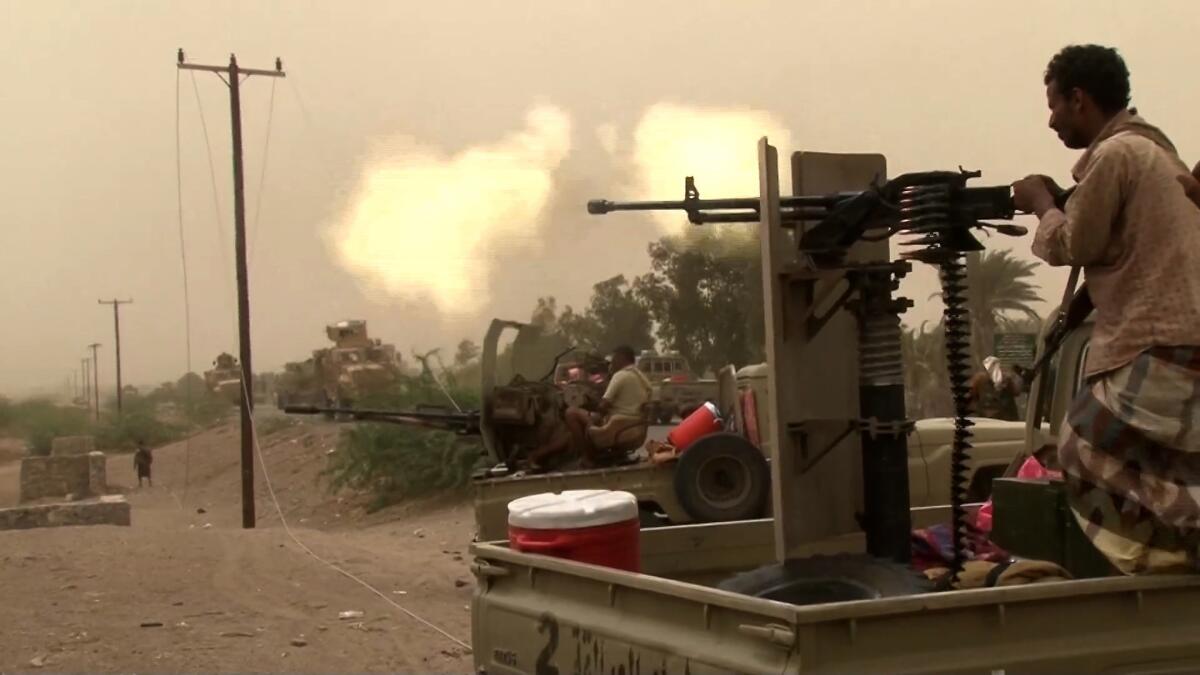 This image grab taken from a video shows Yemeni pro-government forces firing a heavy machine gun at the south of Hodeida airport, in Yemen's Hodeida province