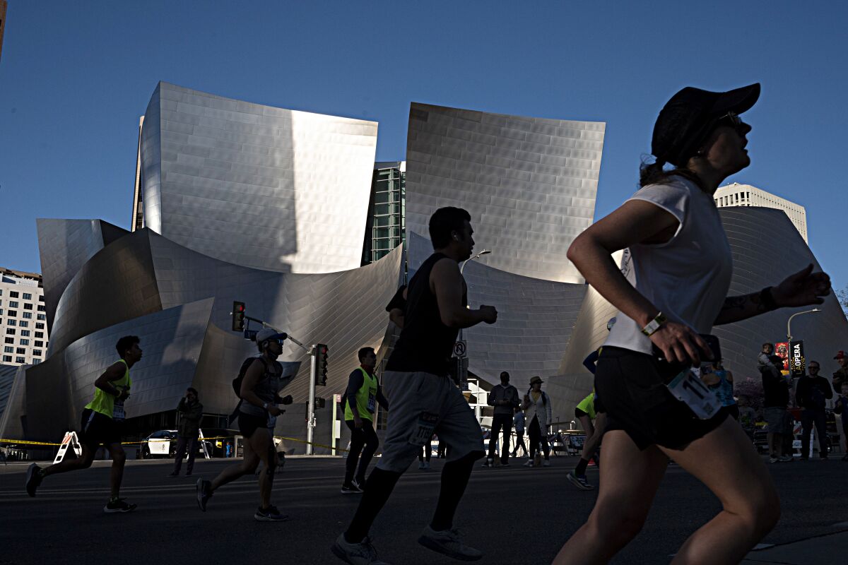 Runners make the turn onto Grand Avenue during the 37th annual Los Angeles Marathon in Los Angeles. 