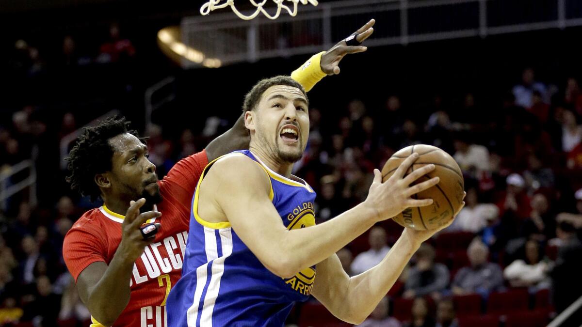 Warriors guard Klay Thompson has hit shot challenged by Rockets guard Patrick Beverly during the first half Thursday night.