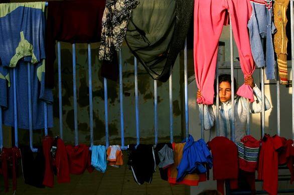 A girl is among the displaced Palestinians staying at a United Nations club in Gaza City, where her family has been living after they lost their house during Israel's offensive in the Gaza Strip.