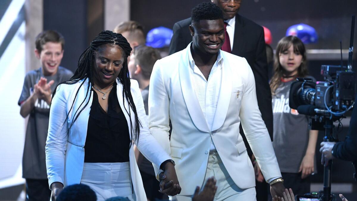 Zion Williamson, right, is introduced with his mother, Sharonda, before the start of the NBA draft on Thursday in New York.