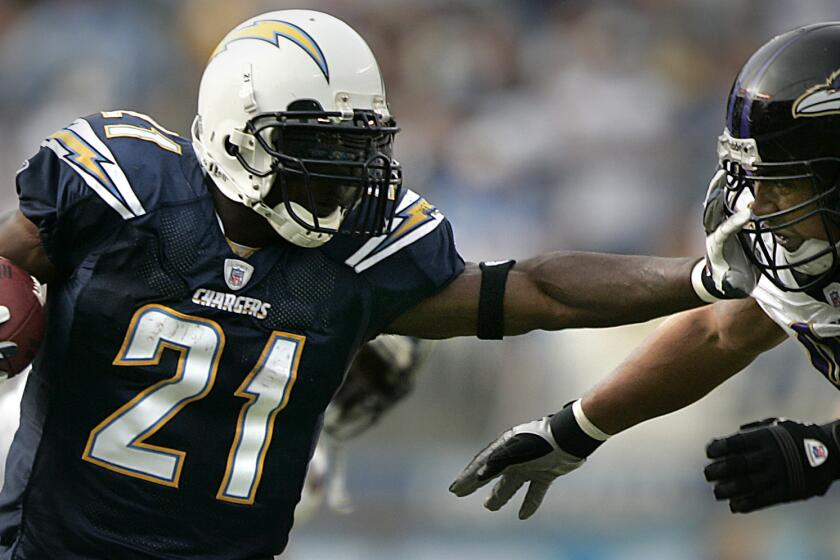 The San Diego Chargers' LaDainian Tomlinson tries to get past the Ravens' Dwan Edwards in 2007.