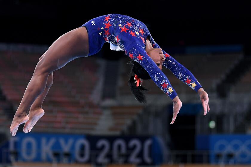 -TOKYO,JAPAN July 24, 2021: USA's Simone Biles competes on the beam in the women's team qualifying at the 2020 Tokyo Olympics. (Wally Skalij /Los Angeles Times)