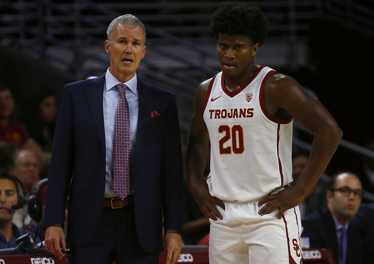 LOS ANGELES, CALIF. - NOV. 19, 2019. USC head coach Andy Enfield talks with guard Ethan Anderson 