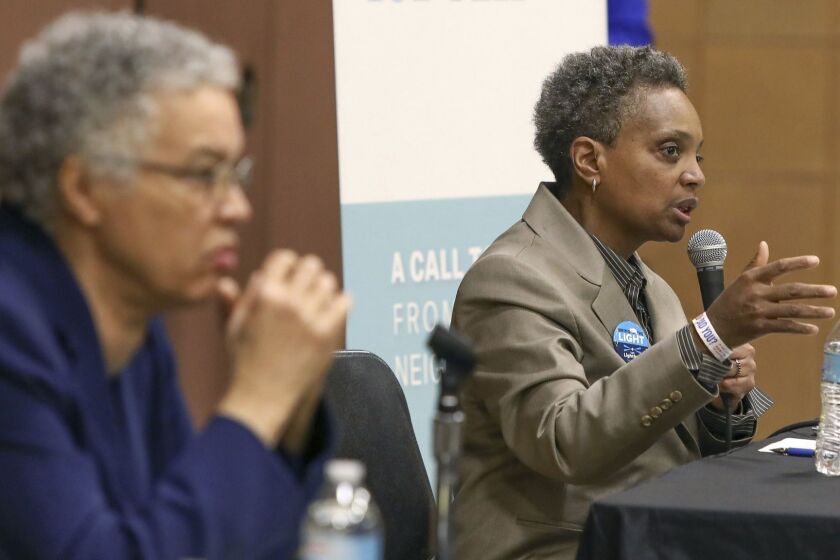 In this March 24, 2019 photo, Chicago mayoral candidate Lori Lightfoot, right, participates in a candidate forum in Chicago. Lightfoot and Toni Preckwinkle, left, are competing to make history by becoming the city's first black, female mayor. On issues their positions are similar. But their resumes are not, and that may make all the difference when voters pick a new mayor on Tuesday, April 2, 2019. (AP Photo/Teresa Crawford)
