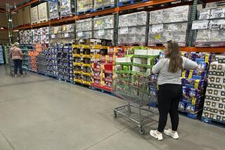 Shoppers consider purchases in a Costco warehouse Thursday, Sept. 12, 2024, in Thornton, Colo. (AP Photo/David Zalubowski)