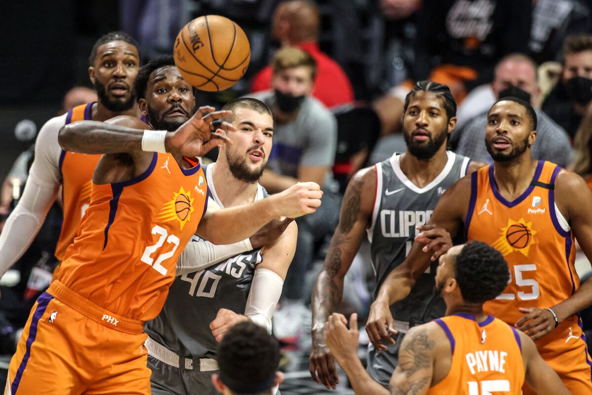 Phoenix Suns center Deandre Ayton (22) looks to control a rebound during first half of the Clippers' 84-80 loss.