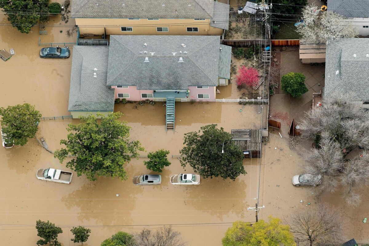 Homes and cars in San Jose are swamped by flooding on Feb. 22.