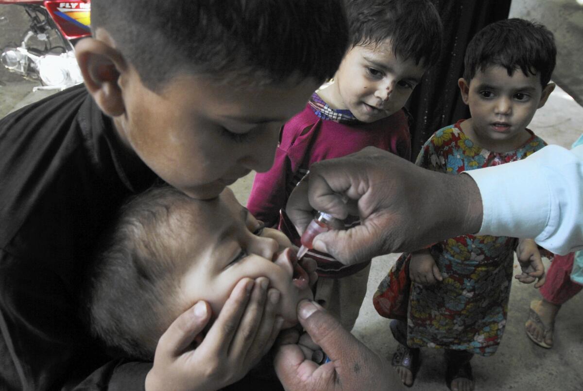 A health worker gives a polio vaccine to a child in Lahore, Pakistan, on May 20. Pakistan is one of only three countries where polio remains endemic.