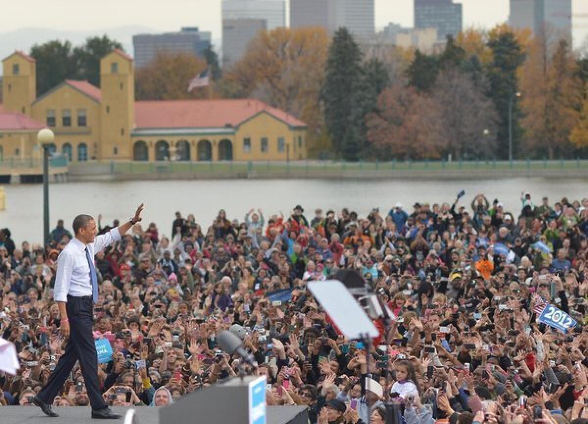President Obama arrives on stage for a campaign event at City Park in Denver.