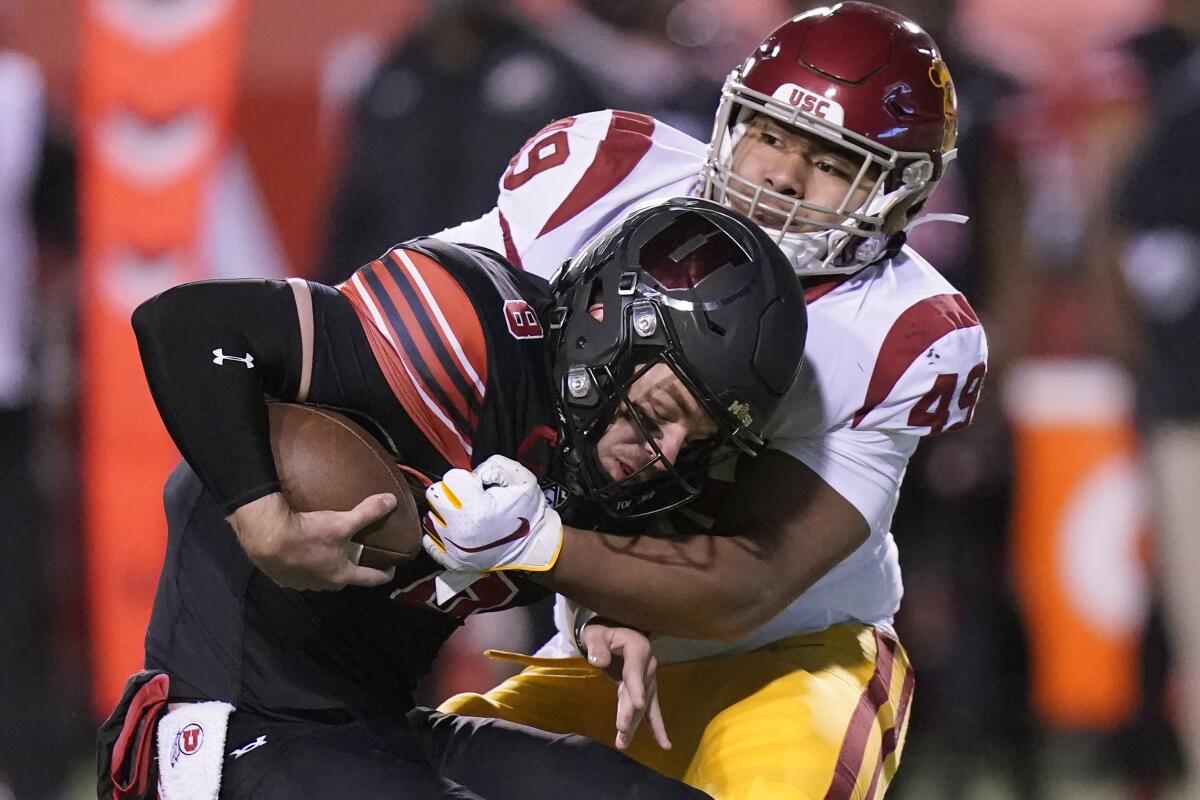 USC defensive lineman Tuli Tuipulotu sacks Utah quarterback Jake Bentley during a game in November 2020.