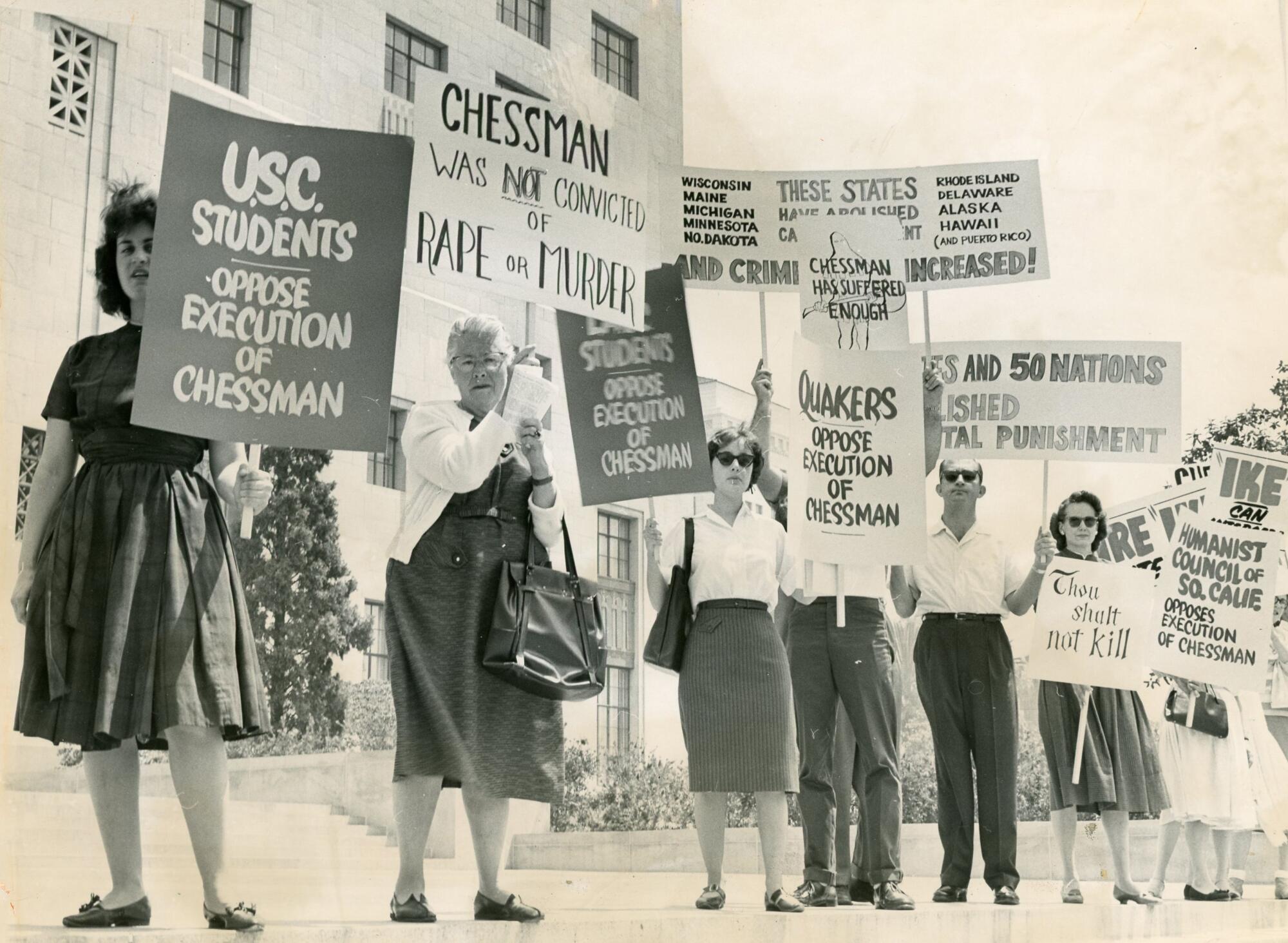 Protesters hold signs opposing Caryl Chessman's execution.  