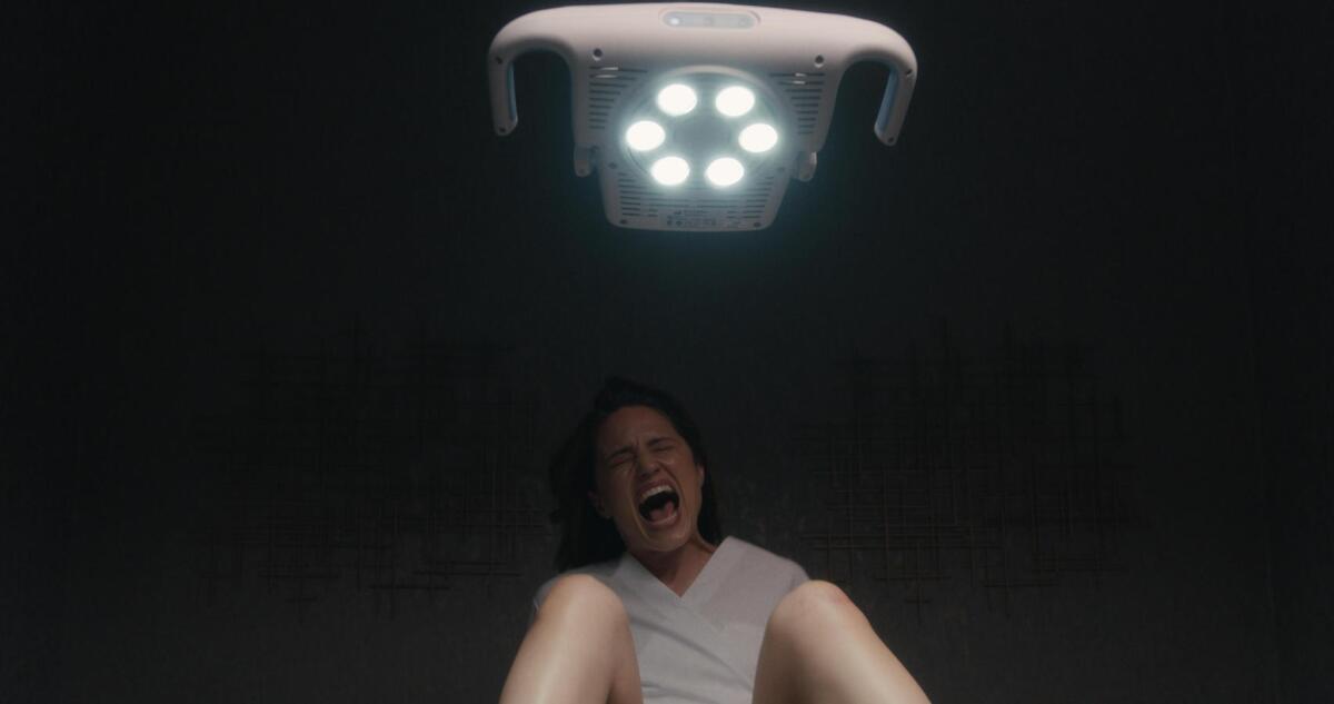 A screaming woman with a medical light overhead