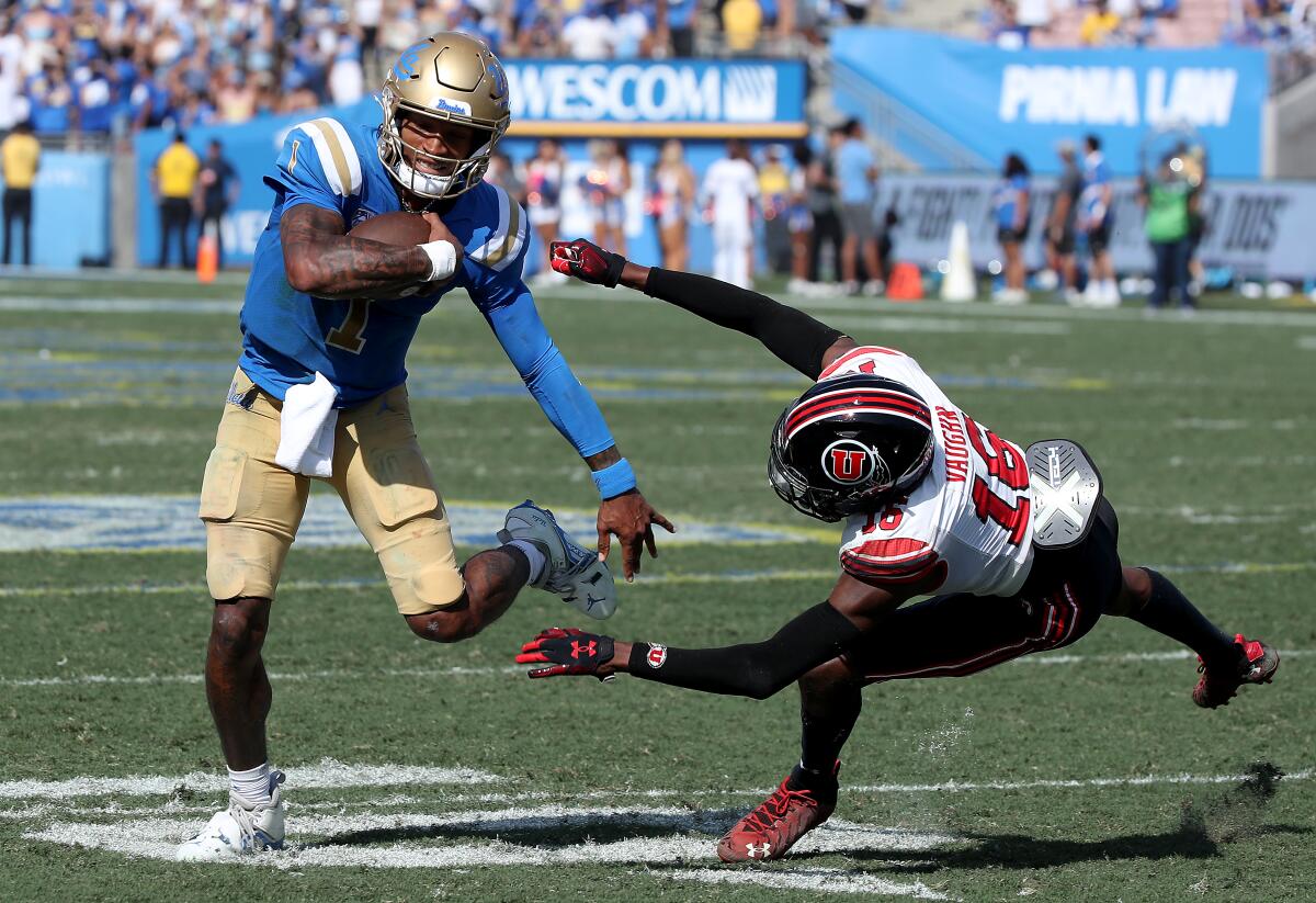 UCLA quarterback Dorian Thompson-Robinson eludes Utah cornerback Zemaiah Vaughn on Oct. 8 at the Rose Bowl.