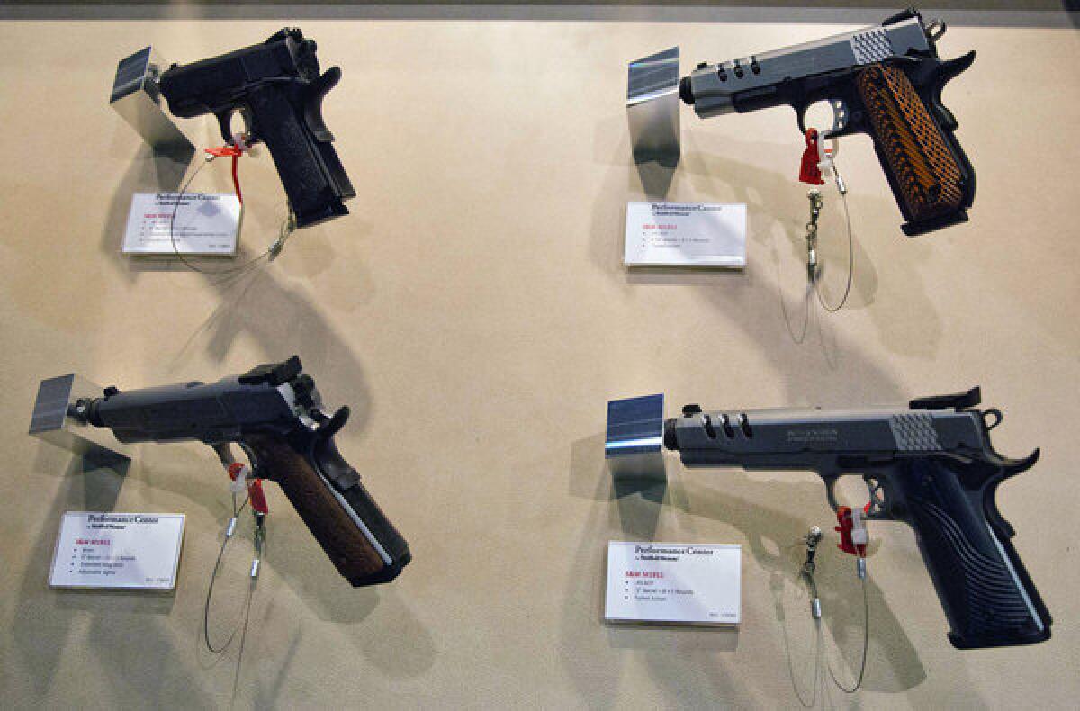 Smith & Wesson pistols are displayed at a gun show in Las Vegas in January. The company reported that its earnings more than tripled in its fiscal third quarter.