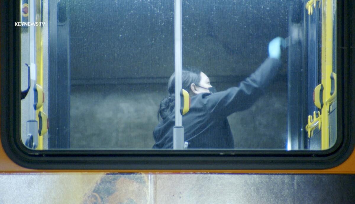 A crime scene investigator dust for fingerprints on a Metro bus after a man died Thursday night, Feb. 22, 2024.