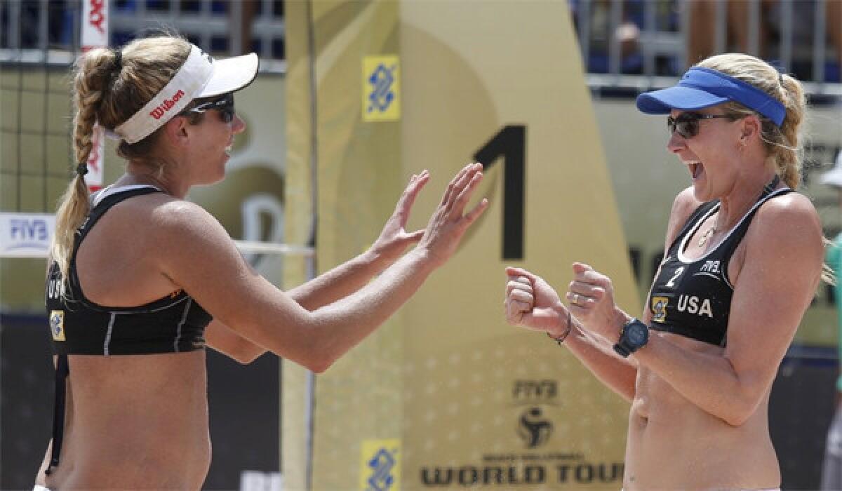 April Ross, left, and Kerri Walsh Jennings defeated Annett Davis and Morgan Miller, 19-21, 21-19, 15-13, to advance to the semifinals of the AVP Championships beach volleyball tournament in Huntington Beach on Saturday.
