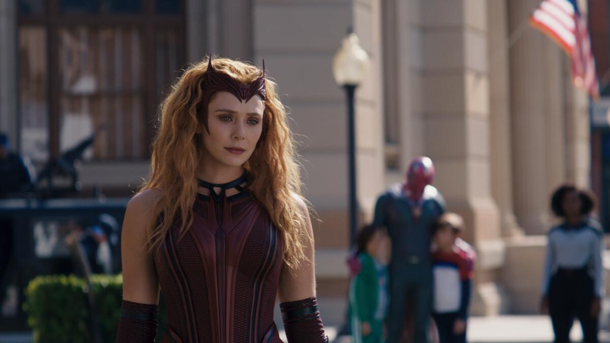 a woman in a superhero outfit looking thoughtful