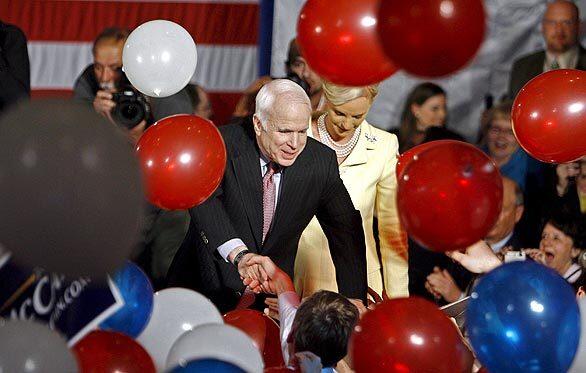 Sen. John McCain and his wife, Cindy, greet supporters Tuesday at his election-night party in Dallas. "We have won enough delegates to claim with confidence, humility and a great sense of responsibility that I will be the Republican nominee," he said. McCain, who swept Tuesday's four primaries, will visit the White House today to receive the endorsement of President Bush.