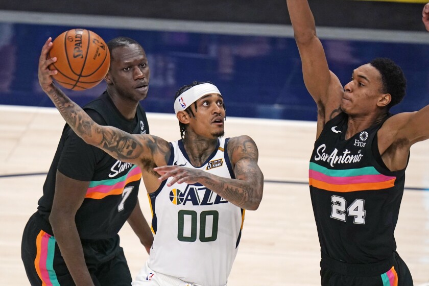 Utah Jazz guard Jordan Clarkson (00) goes to the basket as San Antonio Spurs guard Devin Vassell (24) defends during the second half of an NBA basketball game Wednesday, May 5, 2021, in Salt Lake City. (AP Photo/Rick Bowmer)