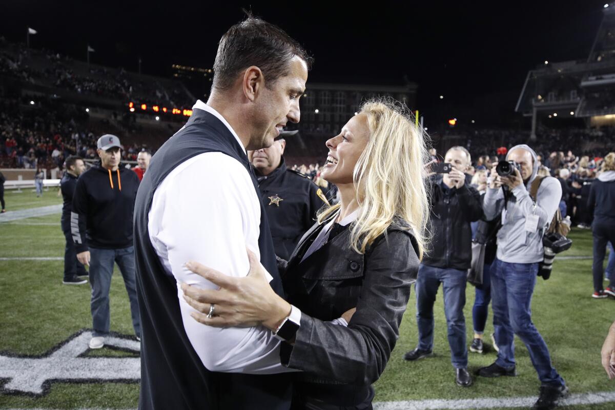 Cincinnati coach Luke Fickell celebrates with his wife, Amy, after a game against UCF at Nippert Stadium on Oct. 4, 2019.