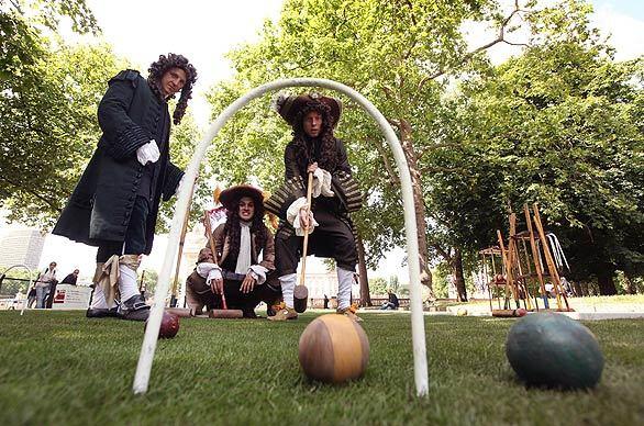 Players dressed in 17th century costume convene on London's Pall Mall to have a go at "paille maille," a once-popular lawn game that gave the famed thoroughfare its name. The stunt kicked off a campaign to educate Londoners and tourists about the history behind the city's roads.