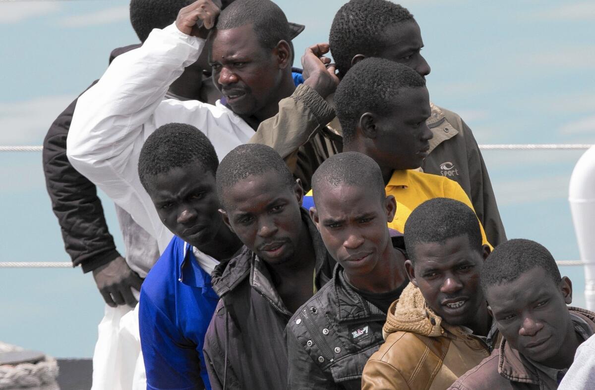 Migrants at Catania harbor in Sicily wait to get off an Italian coast guard ship on April 24, 2015.