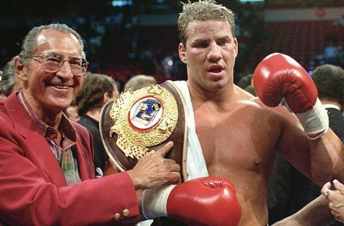 Tommy Morrison celebrates after defeating George Foreman for the WBO heavyweight title.