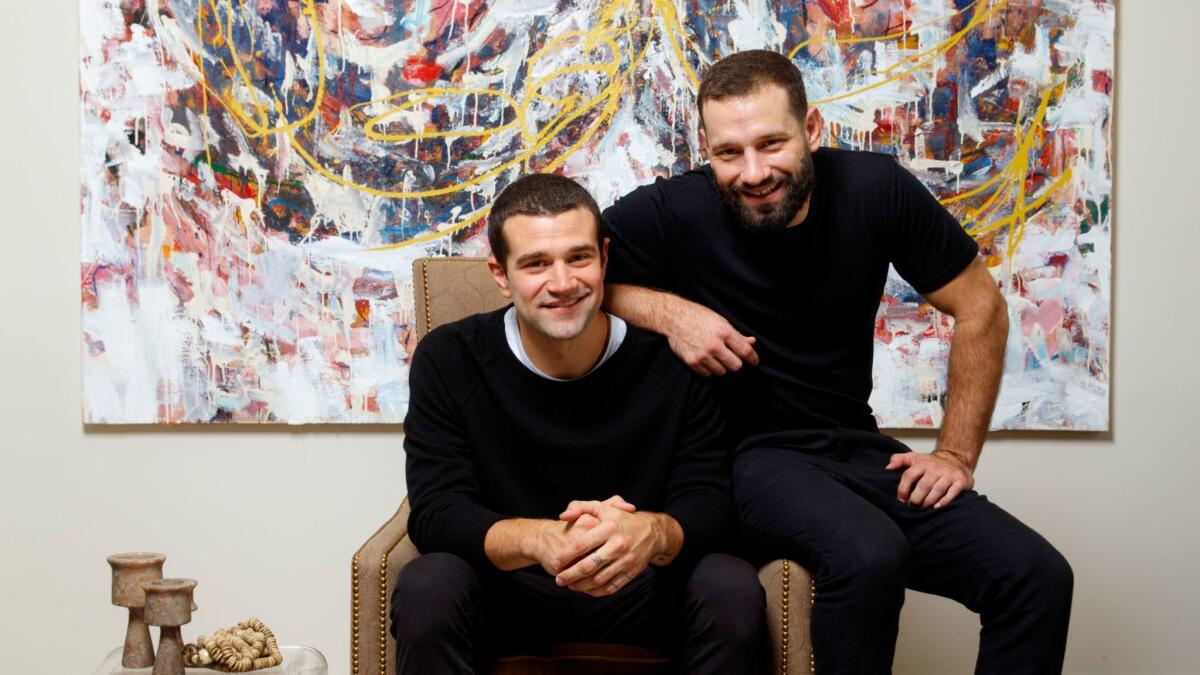 Christopher Hines, seated, and his brother, Billy, founders of the new fashion line Arcady, are shown in their L.A.-area home.