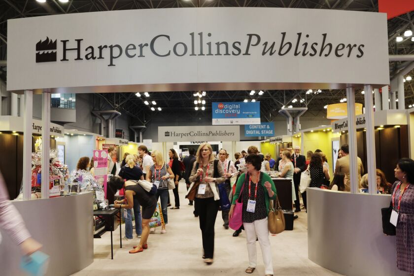 FILE - Attendees at BookExpo America visit the HarperCollins Publishers booth in New York on May 28, 2015. HarperCollins Publishers and the union representing some 250 striking employees have agreed to enter into federal mediation, the first sign of a possible settlement since the work stoppage began in early November. (AP Photo/Mark Lennihan, File)