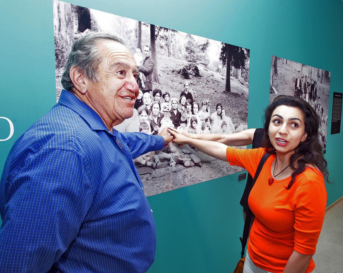 Zaven Kazazian and Tigranna Zakaryan point to a small child in a photograph that they said was recognized by a museum visitor to Mexico City’s Museum of Memory and Tolerance, where the exhibit "Armenia: An Open Wound" ran for a year before coming to Glendale.