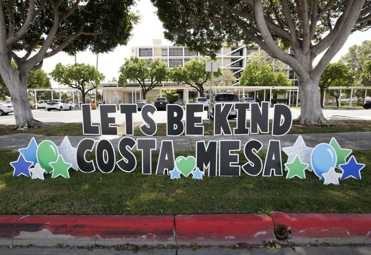 A "Let's Be Kind Costa Mesa" sign is located on Fair Drive near city hall.