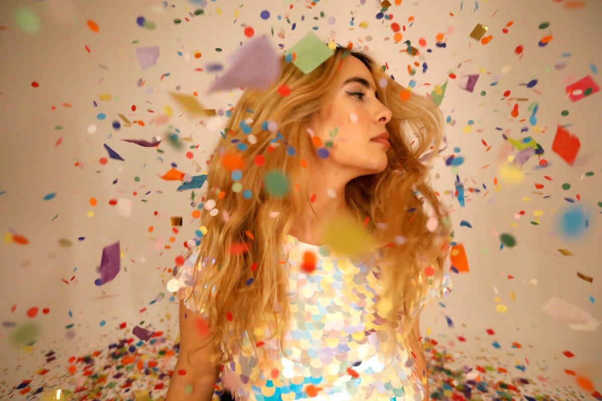 Photographer Jelena Aleksich, immersing herself in confetti.