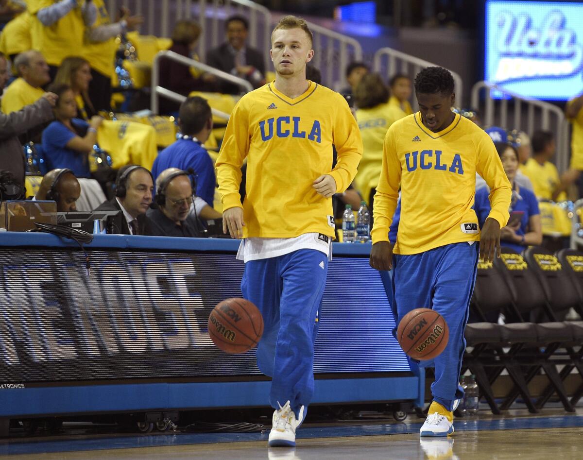UCLA guard Bryce Alford dribbles the ball onto the court followed by Aaron Holiday before a game against Kentucky.