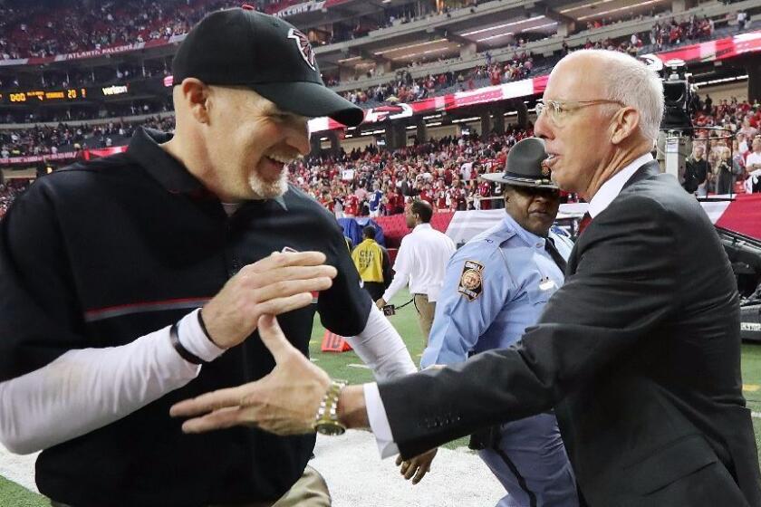Falcons Coach Dan Quinn, left, and team President Rich McKay celebrate a 36-20 playoff victory against the Seattle Seahawks on Jan. 14.