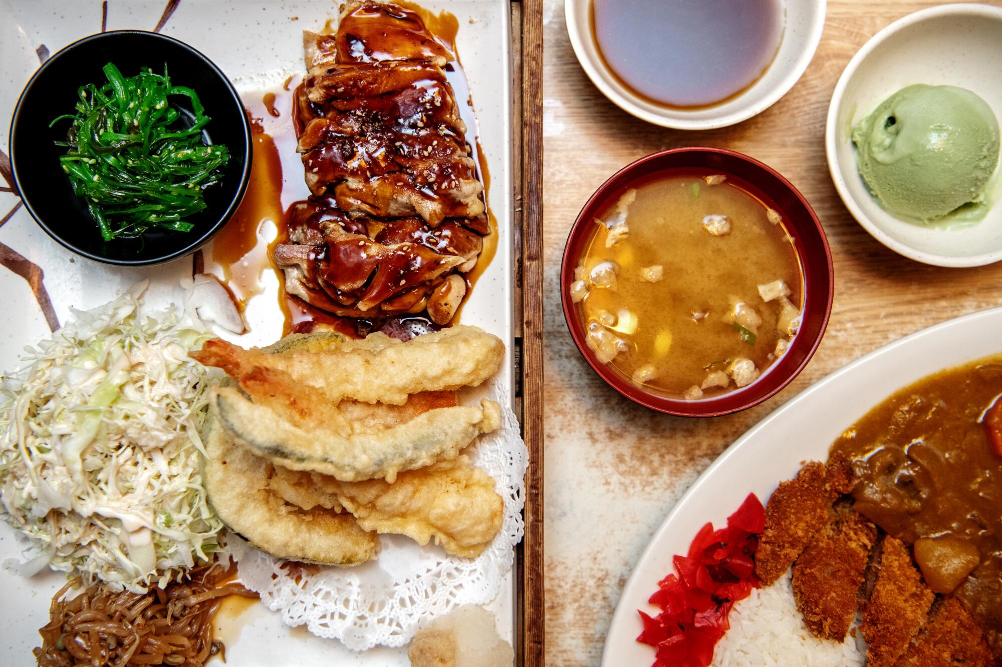Chicken teriyaki and mixed tempura combination plate, left, and katsu curry from Suehiro Café.