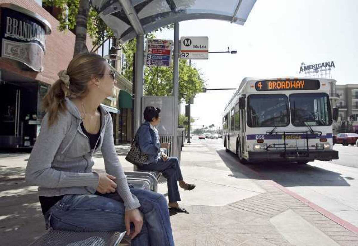 A woman waits for the No. 2 Beeline bus on Brand Blvd. at Harvard St. in Glendale in 2009.