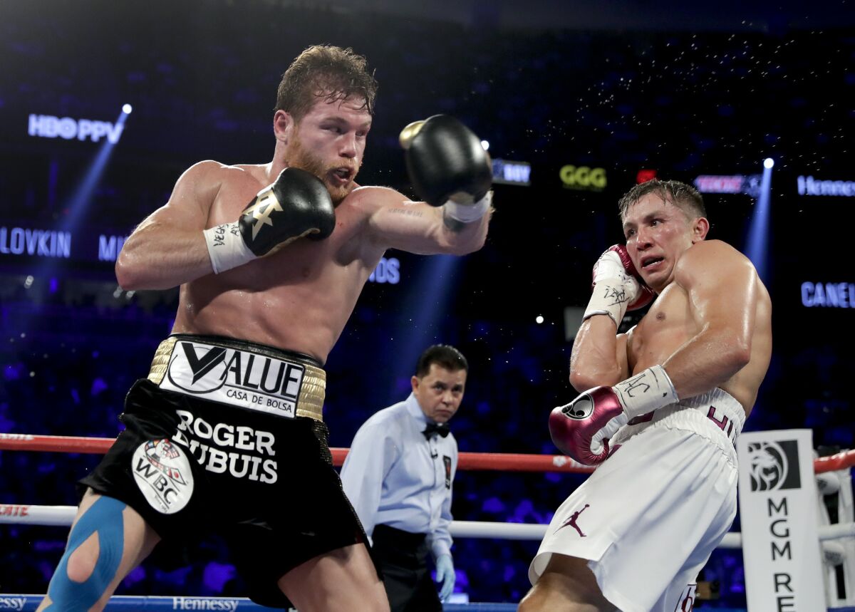 Canelo Alvarez, left, and Gennady Golovkin trade punches during a middleweight title fight