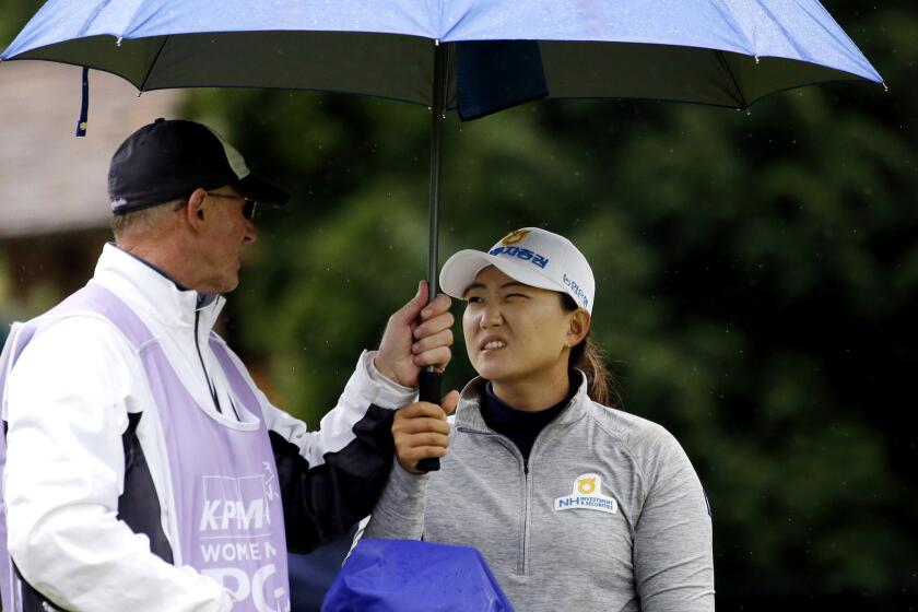 Mirim Lee and caddie Daryl Smith talk strategy on the seventh hole Friday during the second round of the Women¿s PGA Championship.