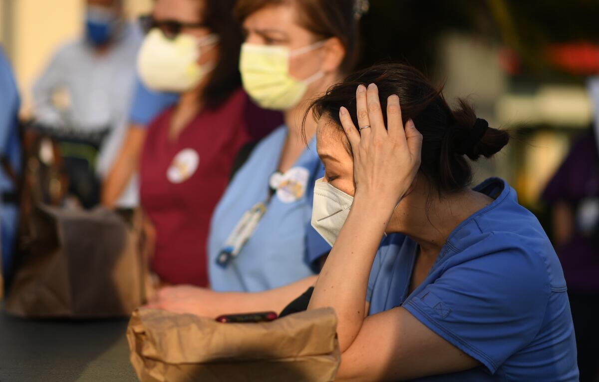 Nurses attend a candlelight vigil