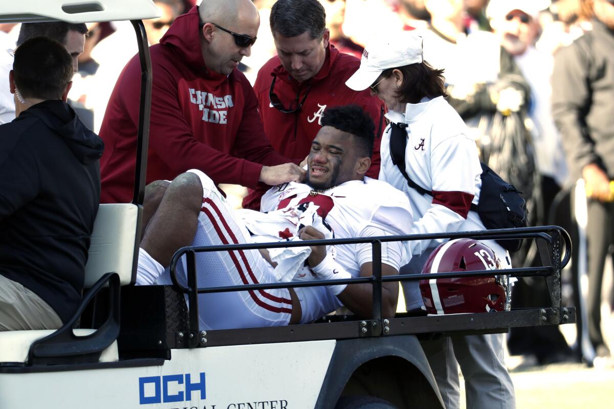 Alabama quarterback Tua Tagovailoa is carted off the field after suffering a season-ending hip injury against Mississippi State on Saturday.