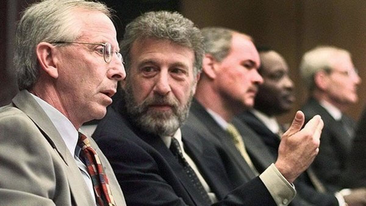 Men's Wearhouse abruptly fired executive chairman George Zimmer last week. Above, Zimmer, second from left, in 1999.