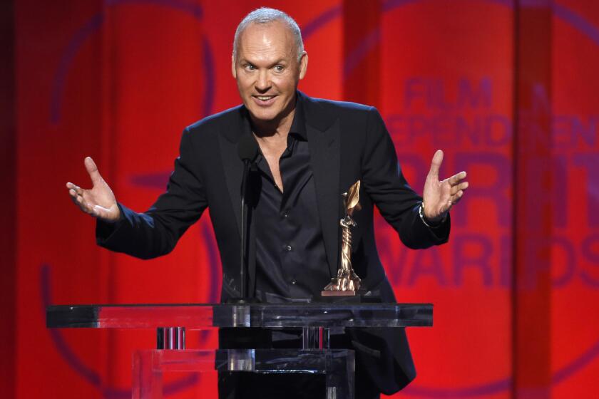 Michael Keaton accepts the award for best male lead for "Birdman" at the Independent Spirit Awards.