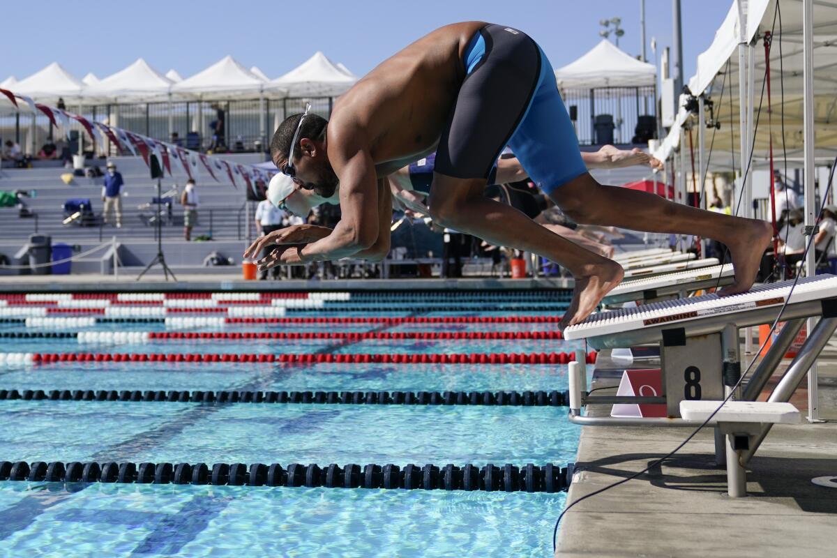 Ous Mellouli dives in for the men's 400 meter freestyle at the U.S. Open swimming championships Friday, Nov. 13, 2020, in Irvine, Calif. (AP Photo/Ashley Landis)