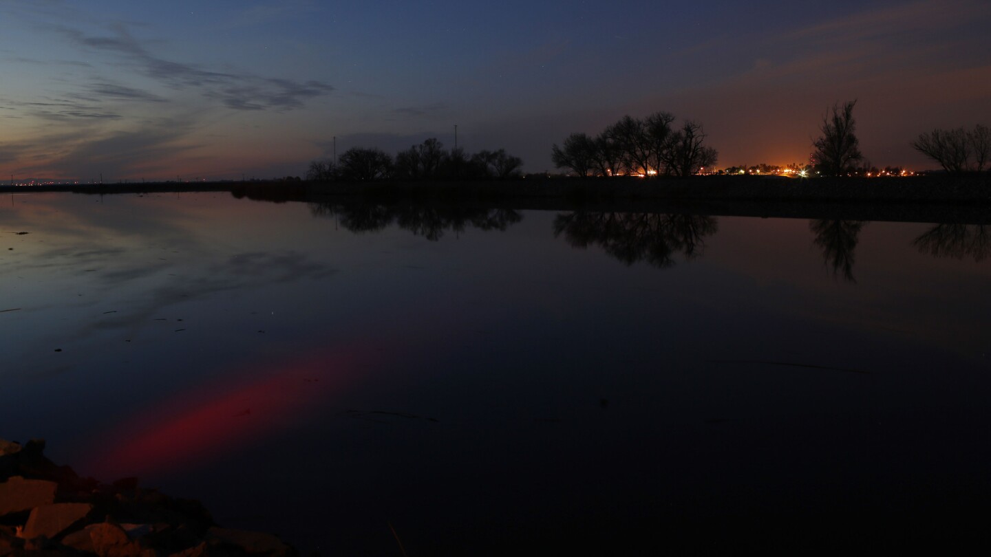 Ssunset is reflected in the Middle River in the Sacramento-San Joaquin Delta.