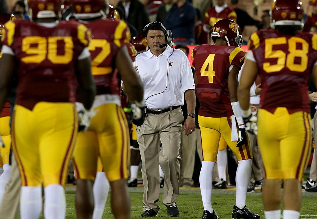 USC Interim Coach Ed Orgeron has had to embrace a somewhat unusual strategy in trying to recruit high school players for a program that is in between head coaches.