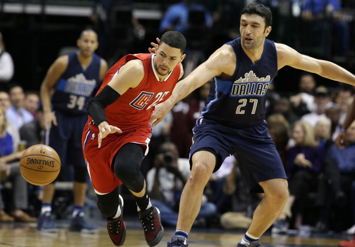 Clippers guard Austin Rivers steals the ball from Mavericks center Zaza Pachulia (27) in the first half.