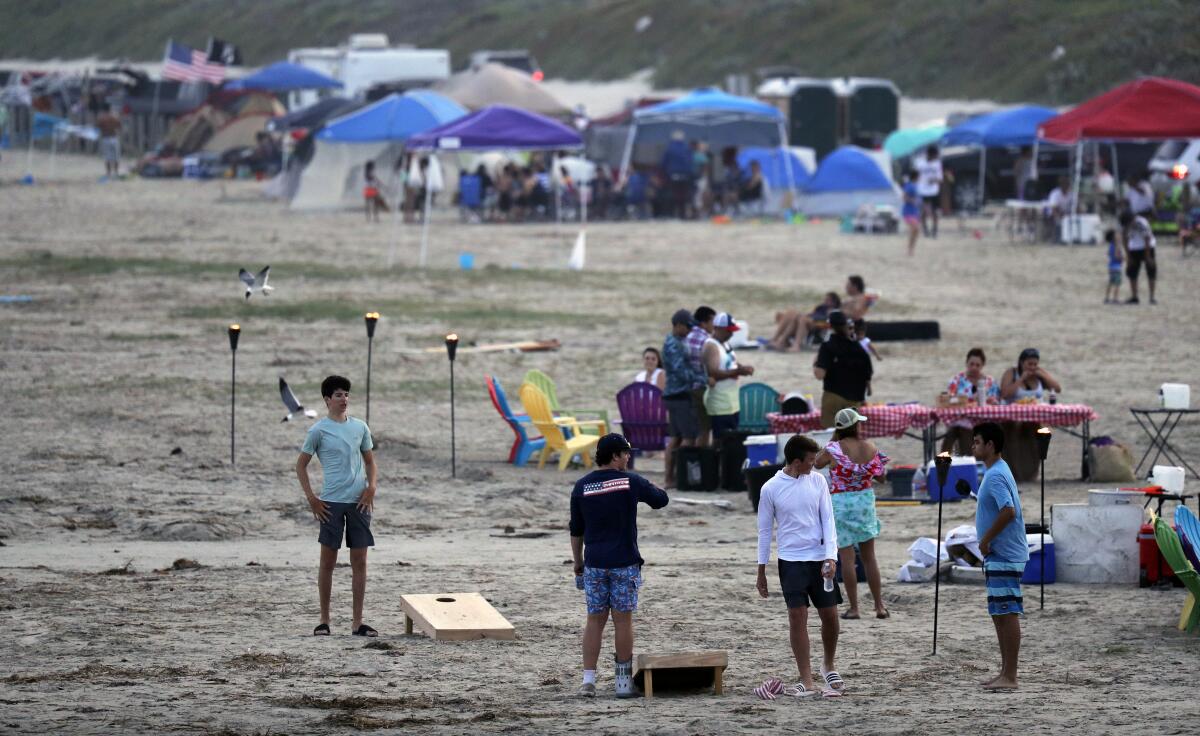 Cientos de personas disfrutan de la playa el sábado 23 de mayo de 2020, en el fin de semana feriado por el Día de los Caídos en las Guerras, en Port Aransas, Texas, en medio de la pandemia del coronavirus. (Eric Gay)